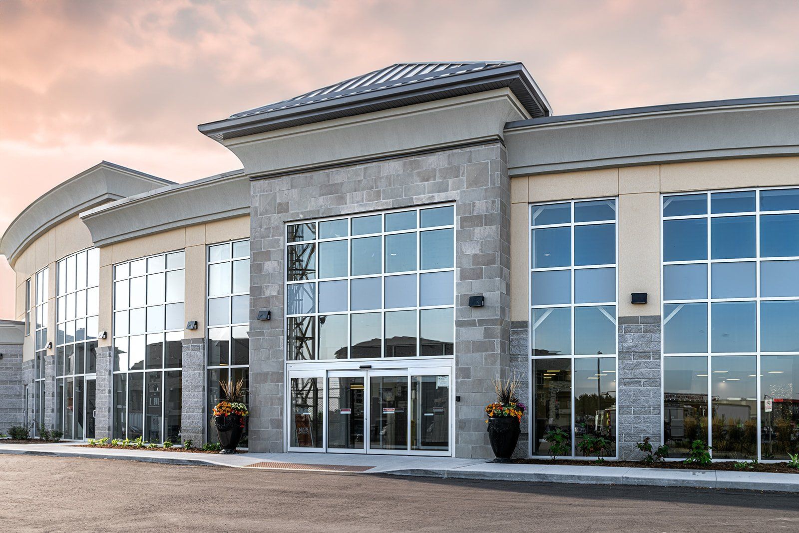 Hope City Church's new building, grey stone and cream panels with tall glass windows around a sliding-door entrance